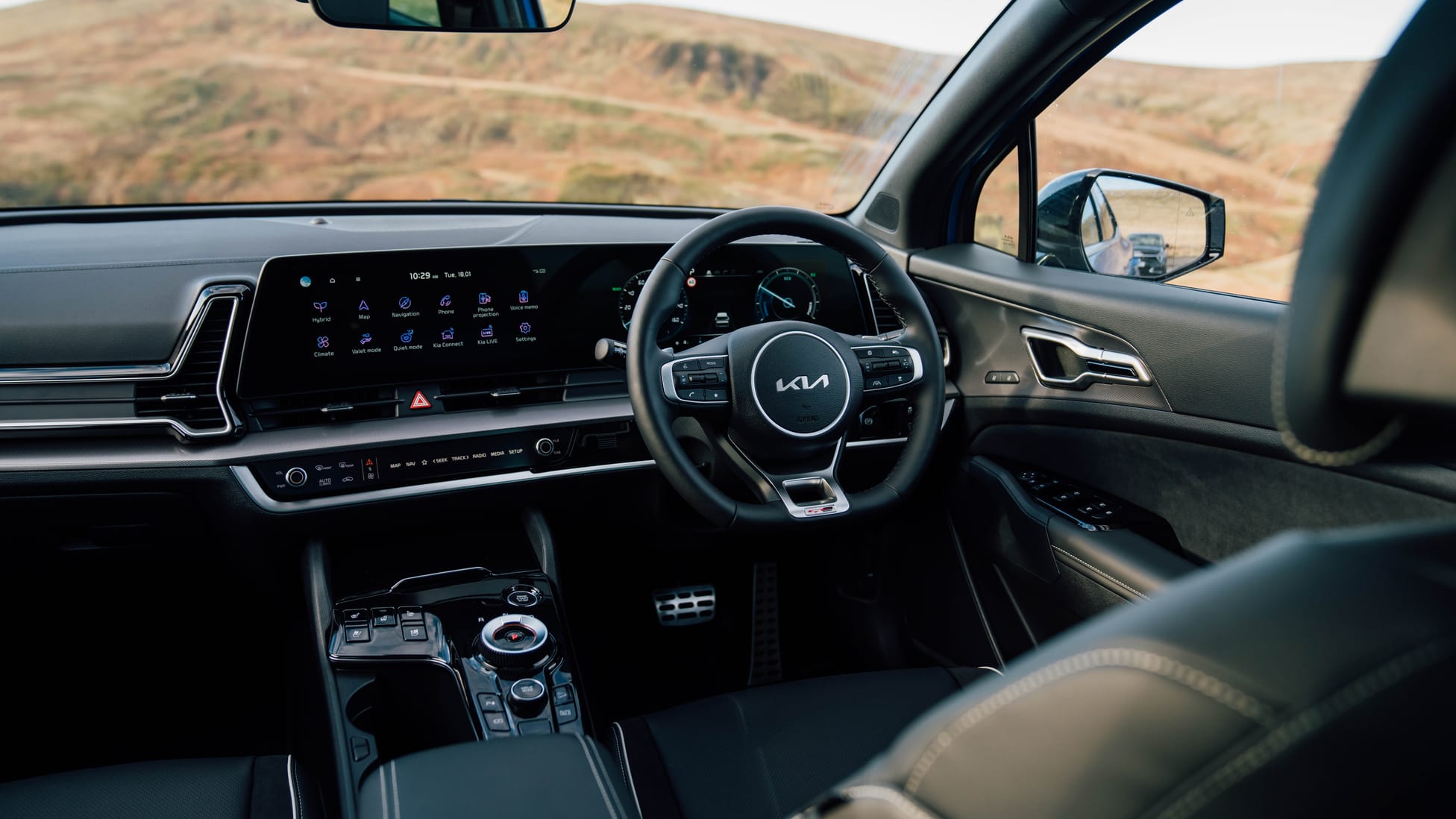 Kia Sportage interior featuring the center console and infotainment layout for a comfortable driver-focused cabin
