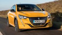 Driving shot of yellow Peugeot 208