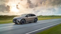 Driving shot of Mercedes Benz EQE SUV with sunset backdrop