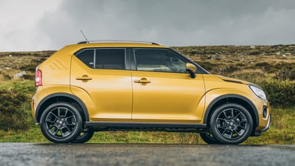 Side profile static shot of yellow Suzuki Ignis