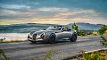 Static shot of Weismann Thunderbolt on scenic road with mountainous backdrop