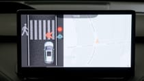 Internal screen display showing car stopping for pedestrian crossing and signals displayed on front of vehicle