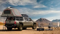 Toyota Tacoma with camper equipment attached, rooftop tent open