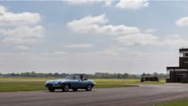 Driving shot of Jag E-type from front