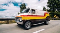 Driving shot of a 1977 Dodge Tradesman restored into a festival camper