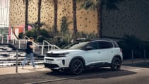 Static shot of C5 Aircross hybrid with street scene in backdrop
