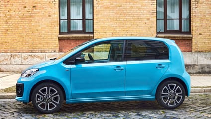 Static side profile shot of VW UP! in bright blue on street