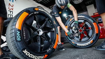 Formula E pit lane crew member with two Hankook tyres 
