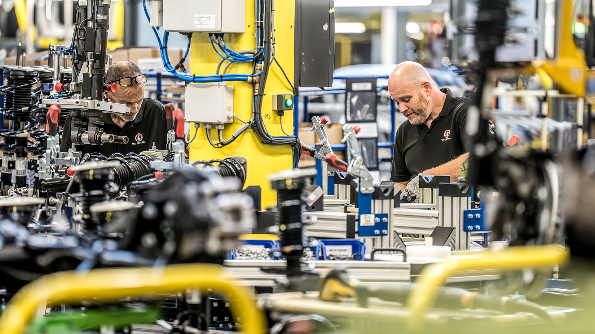 Line workers assemble components at Stellantis' Ellesmere Port EV plant