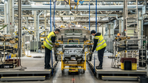 Two line workers in hi-vis vests on the line at Stellantis' Ellesmere Port plant which has moved to electric-only output