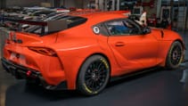 Static garage shot of Toyota GR Supra GT4 100 Edition, rear three-quarter