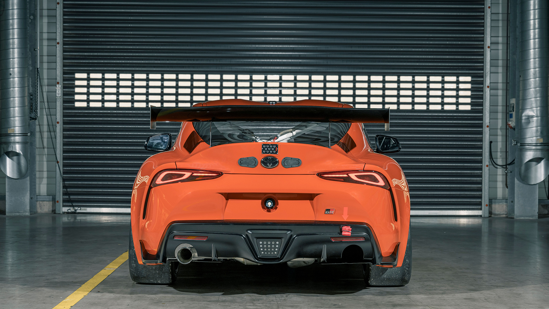 Static garage shot of Toyota GR Supra GT4 100 Edition, rear dead-on