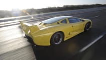 Rear driving shot of the Jaguar XJ220 on track