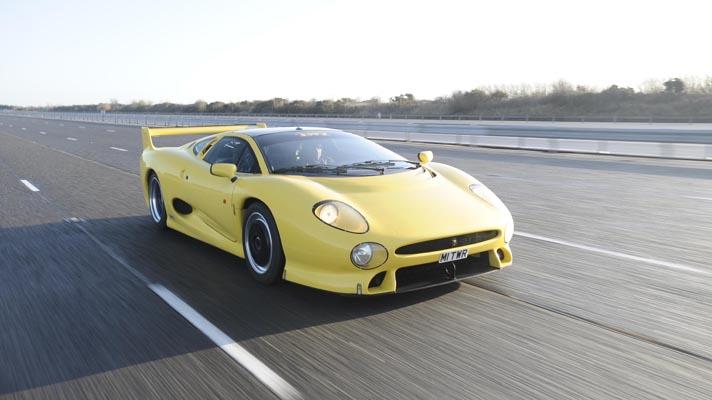Front facing driving shot of the Jaguar XJ220 on track