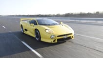 Front facing driving shot of the Jaguar XJ220 on track