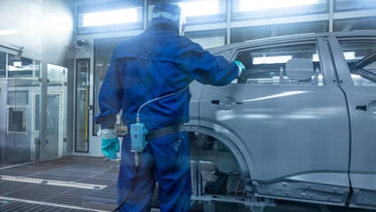 Technician in paint shop checks body shell