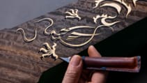 Close up of Rolls Royce craftsperson detailing the dragon marquetry on the Phantom Dragon one-off variant