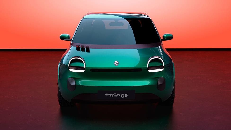 Dead on front facing shot of Renault Twingo E-Tech prototype on stage with peach coloured backdrop