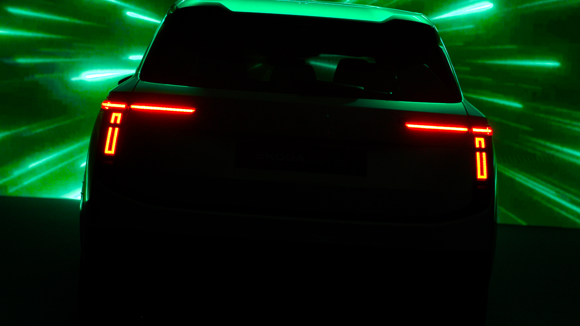 A shadowed teaser image of Skoda Vision 7S, from rear