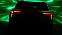 A shadowed teaser image of Skoda Vision 7S, from rear