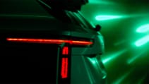 A shadowed teaser image of Skoda Vision 7S, close up of rear lights