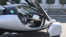 Side profile of Aptera solar car with door open and peek into the cockpit