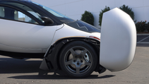 Side shot of Aptera solar car with wheel covers up