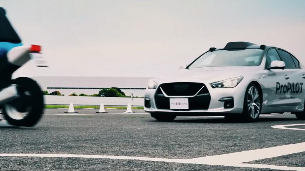 Nissan Propilot test car on test track applying hard brake to miss motorcyclist, leaving frame to left