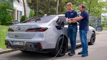 BMW and Solid Power colleagues review analysis while standing next to i7 with ASSBs fitted