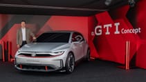 VW cars boss Thomas Schaefer standing next to electric GTI concept
