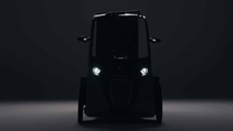 Static shot of a Hopper e-Bike (covered trike) in the dark with headlights on