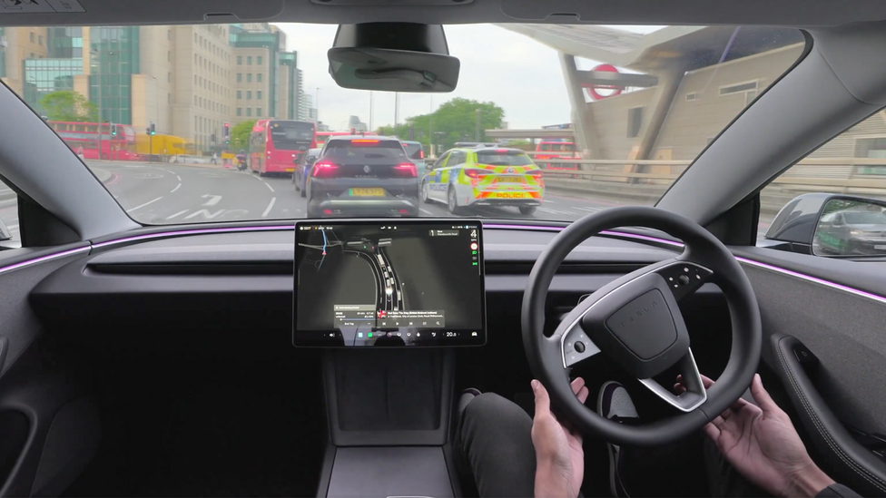 Interior shot looking out of windscreen in a Tesla which has FSDSupervised deployed for the first time in London