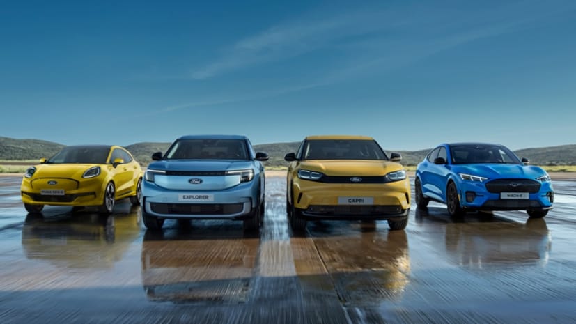 Four All-Electric Ford vehicles on a wet track: All‑Electric Ford Puma Gen‑E® in Electric Yellow; All-Electric Ford Explorer®; All-Electric Ford Capri®; Ford Mustang Mach‑E®