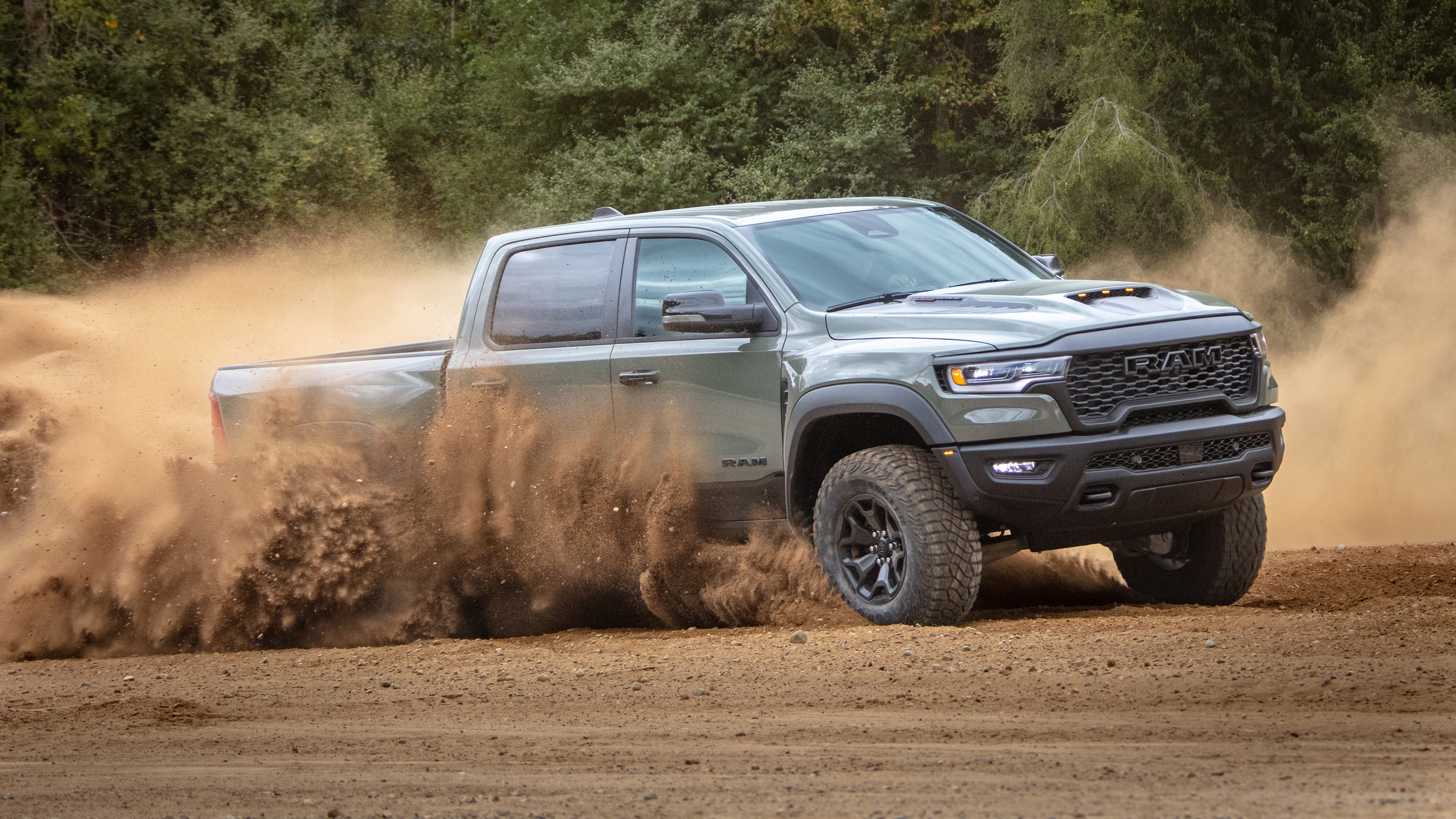 RAM 1500 driving on a dusty road creating a dust storm