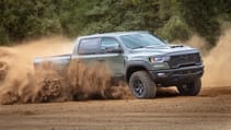 RAM 1500 driving on a dusty road creating a dust storm