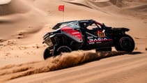 Dacia Dakar Rally car racing on a sand dune