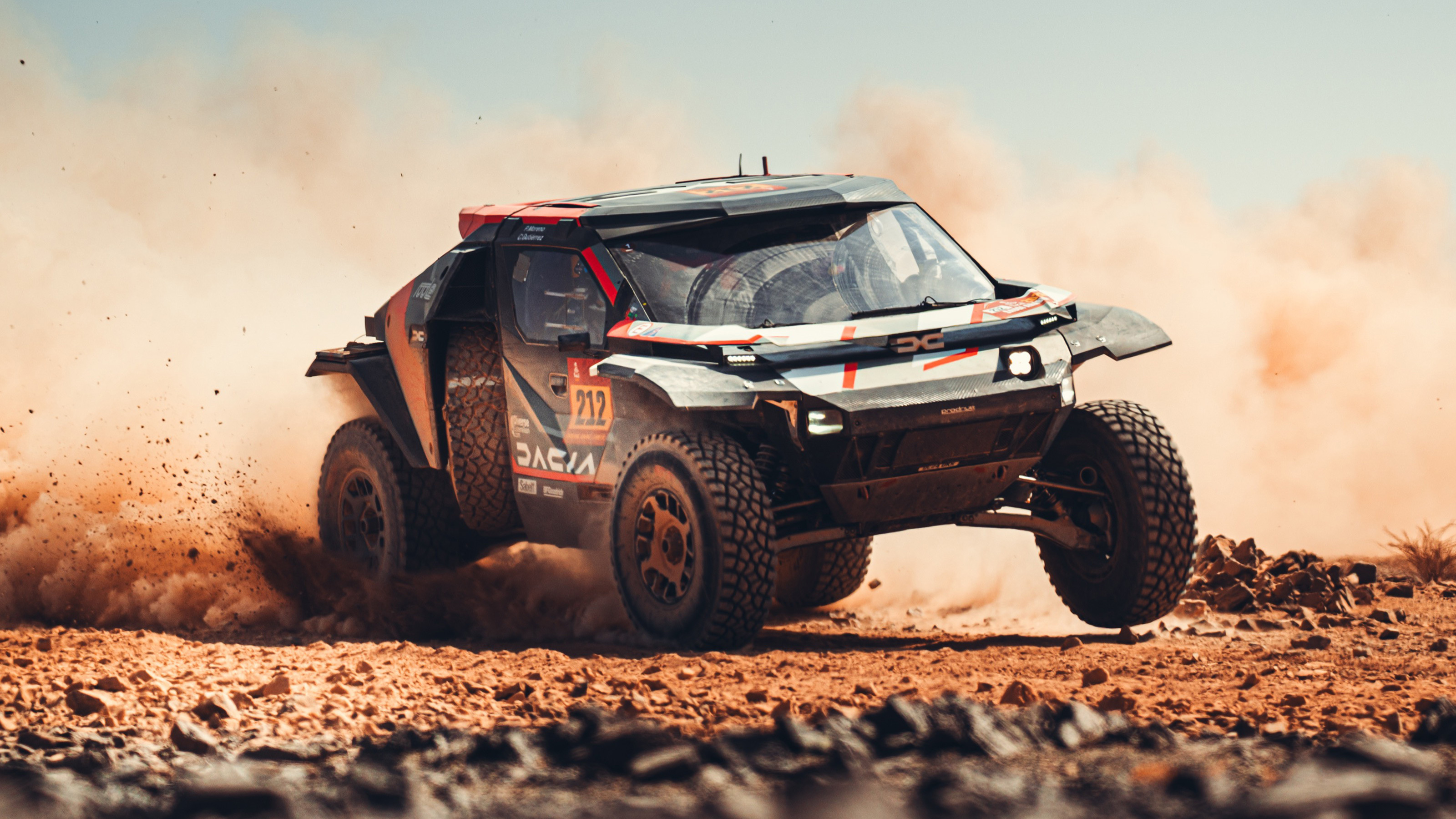 Dacia Dakar Rally car racing on a sand dune
