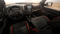 Ram 1500 TRX interior featuring black leather seats with red accents, a digital dashboard, and a large touchscreen display.