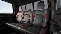 The interior of Ram 150 TRX featuring black leather seats with red accents and a black floor mat.
