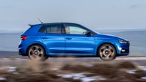 Skoda Fabia driving on a road.