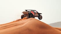 Dacia Dakar Rally car racing on a sand dune