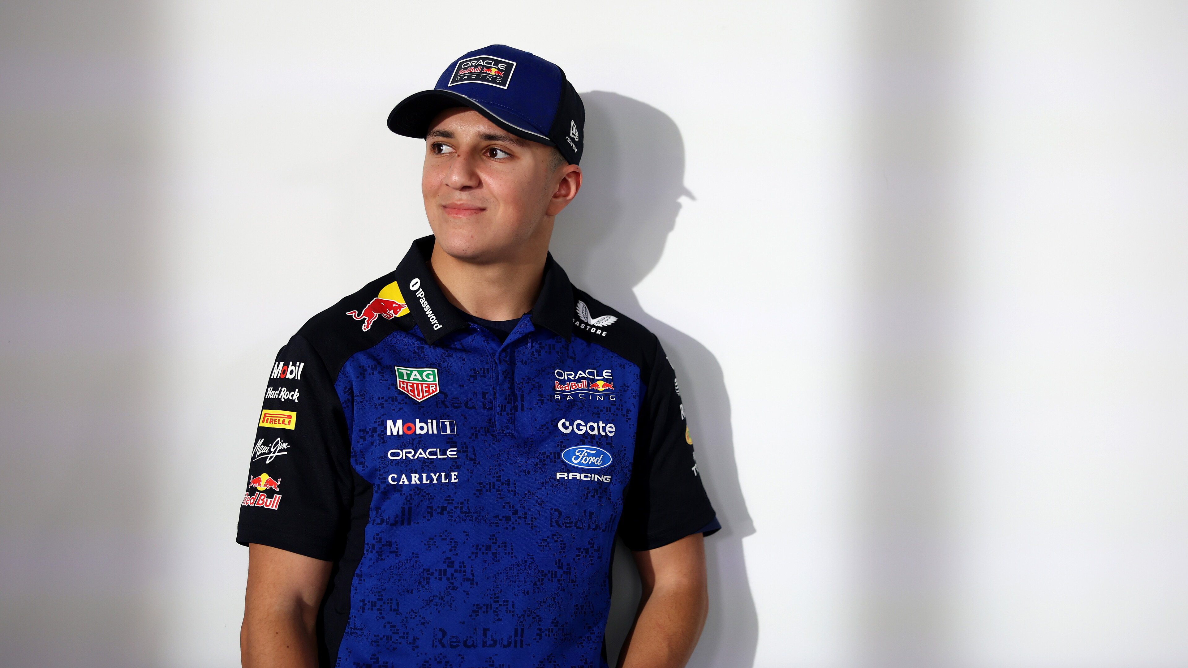 Isack Hadjar pictured against a white wall