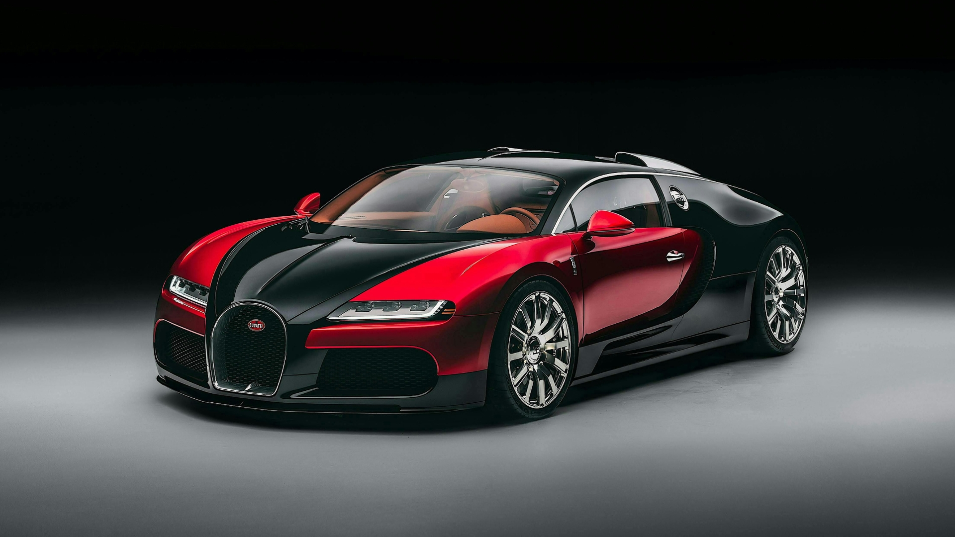 Bugatti Veyron on a grey floor against a black studio background