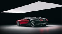 Bugatti Veyron on a grey floor against a black studio background