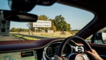 A view from inside a car approaching a border crossing sign that reads "Bienvenue en FRANCE, Welcome to FRANCE".