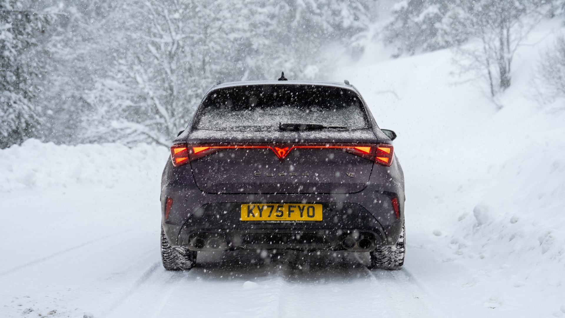Cupra Leon Estate VZ1 pictured from the back driving through the snow