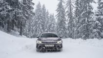 Cupra Leon Estate VZ1 pictured from the front driving through the snow