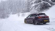 Cupra Leon Estate VZ1 pictured from the back driving through the snow