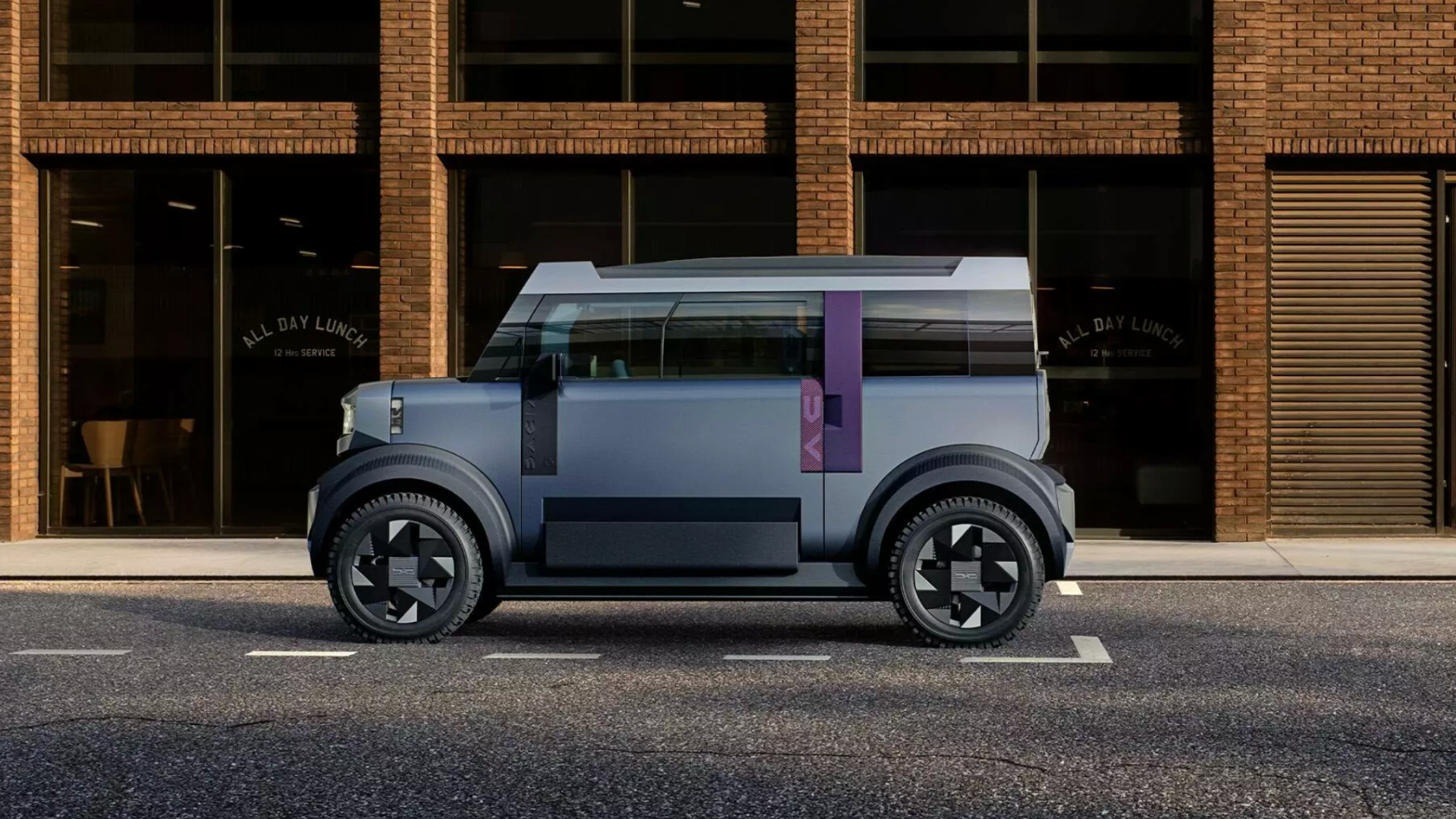 Dacia Hipster pictured from the side, parked against a building.