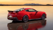 Mustang Dark Horse with a sunset sky in the background